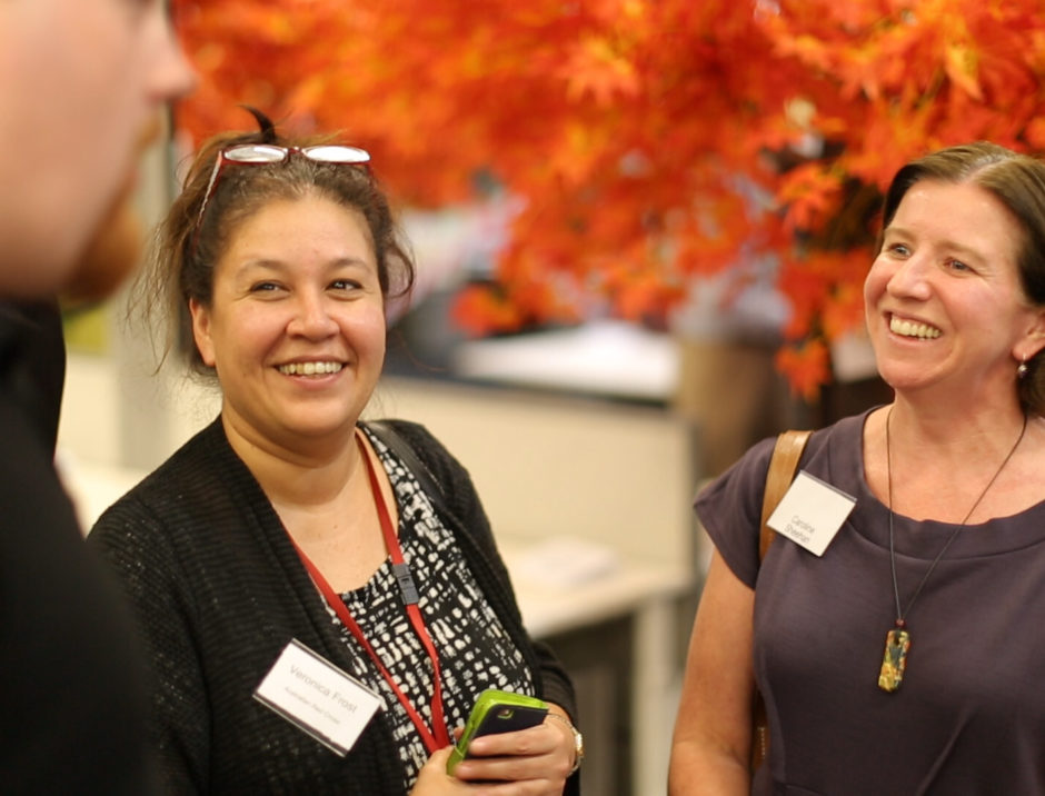 Smiling women at coworking space function