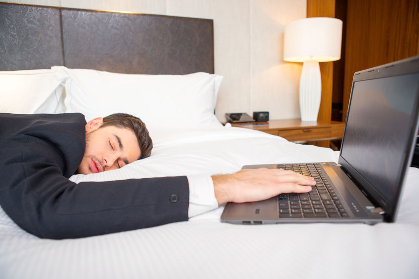 Man on bed asleep with computer